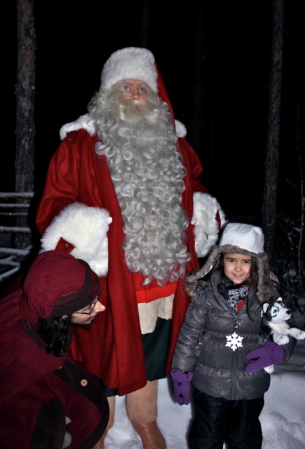 Mia with Santa and one of his elves in the snow covered forest at his home! 